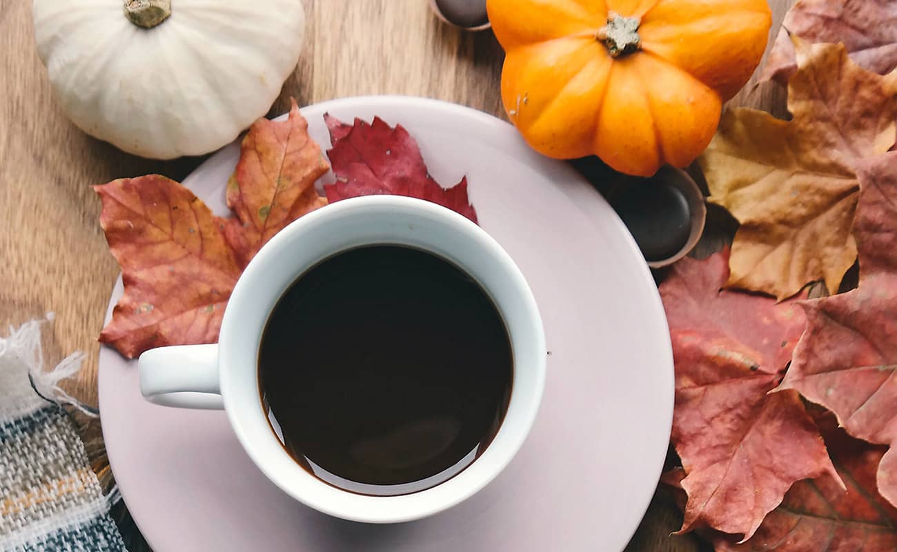 Cup of Black Coffee and Pumpkins with Maple Leaves Cup of Black Coffee and Pumpkins with Maple Leaves